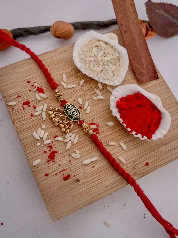 Traditional Shree Ram Gold-Plated Designer Rakhi with Red Mauli Thread
